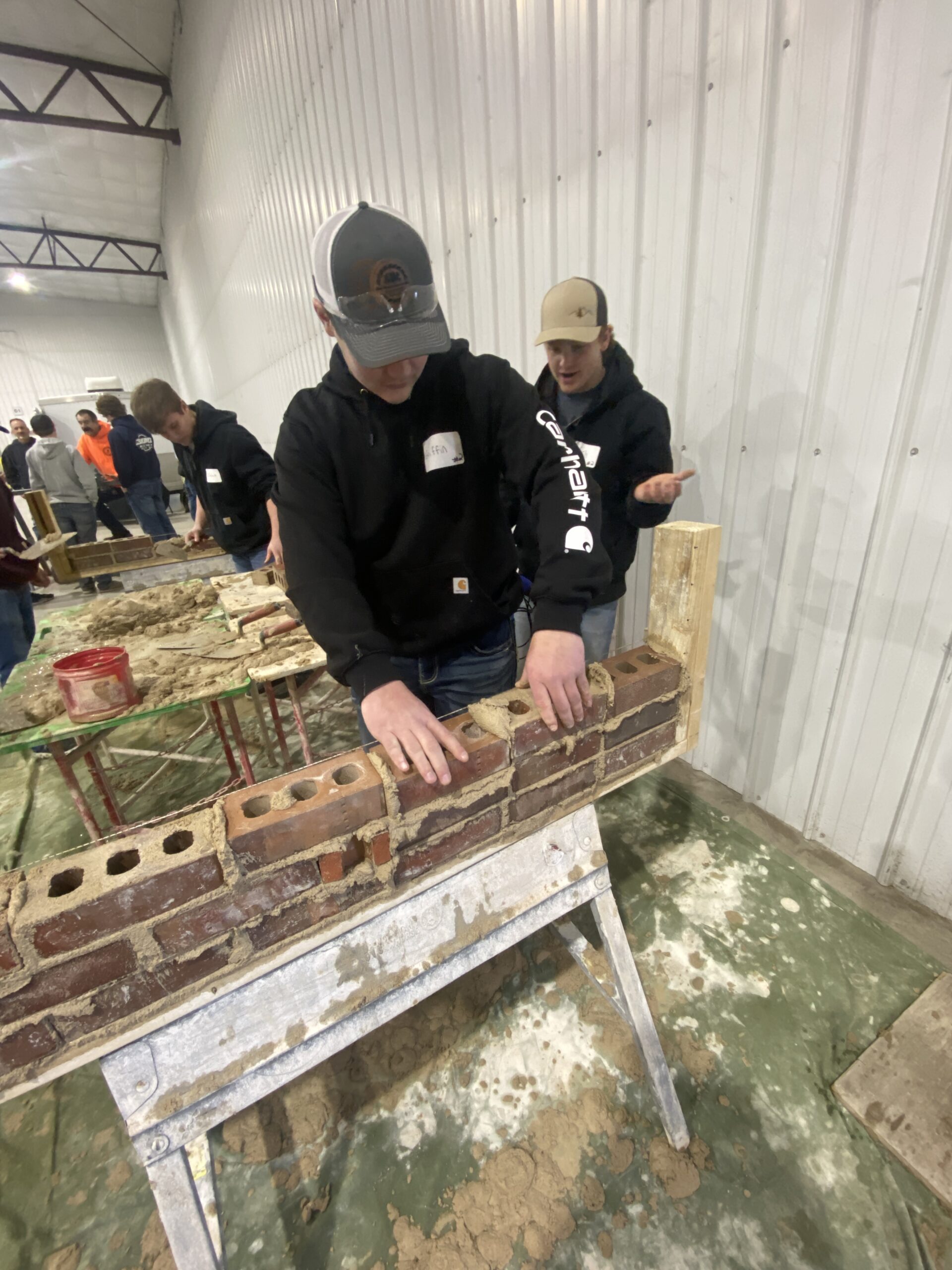 Student learns bricklaying techniques.